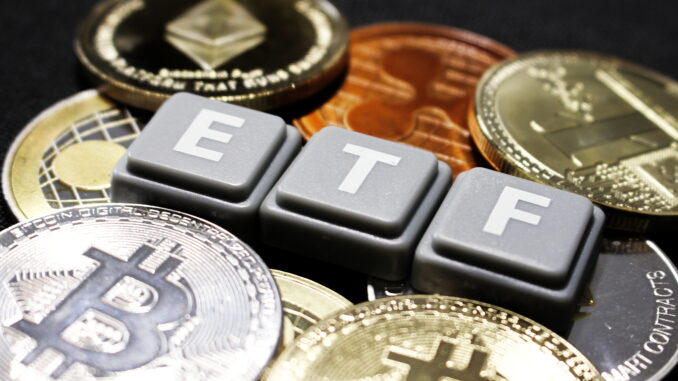 Picture of ETF written with scrabble tiles with crypto coins around it