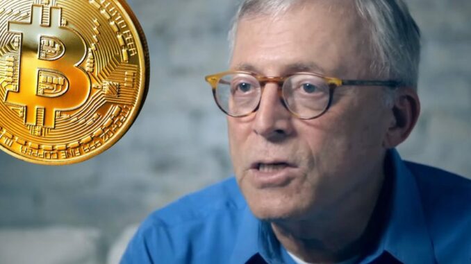 Steve Hanke with a bitcoin next to him