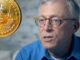 Steve Hanke with a bitcoin next to him