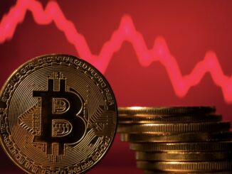 Bitcoins in front of a red downward chart